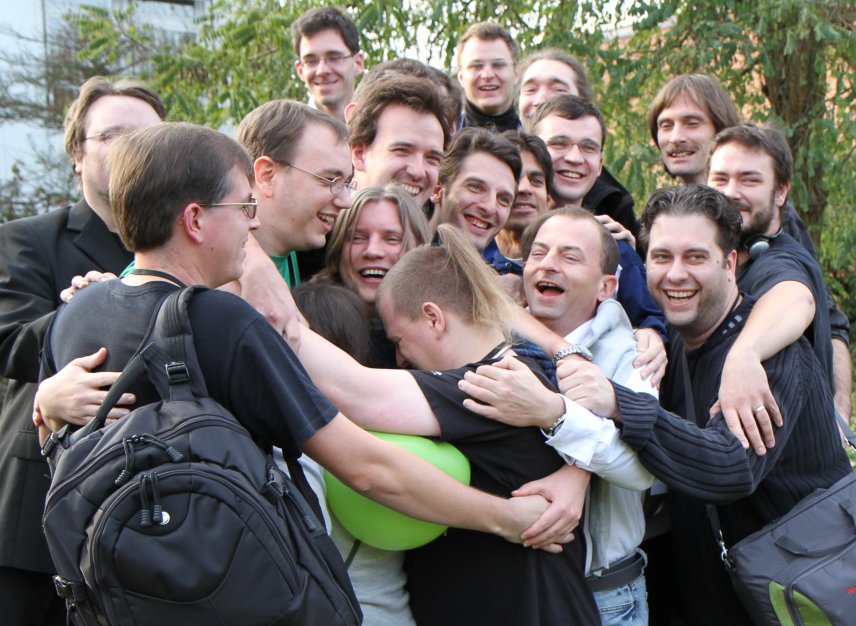 openSUSE Community Members hugging